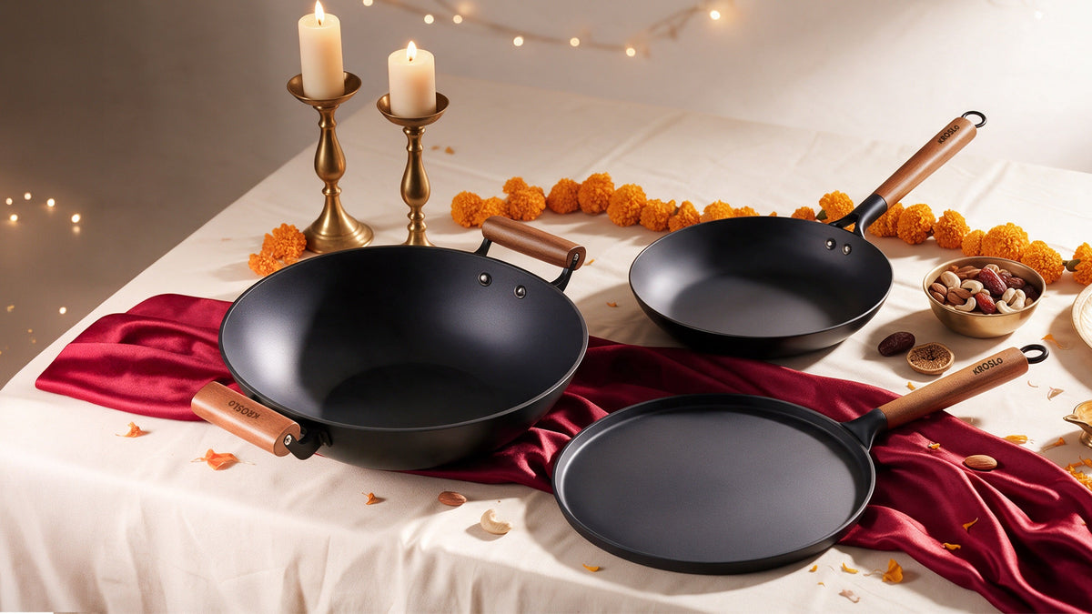 Three cast iron pans with candles, marigolds and dry fruits on a festive table