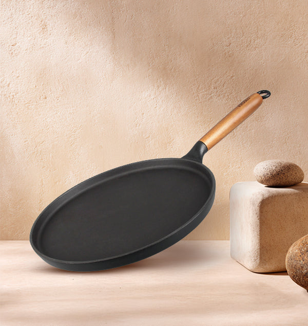 Kroslo cast iron dosa tawa with acacia wood handle on a cream background