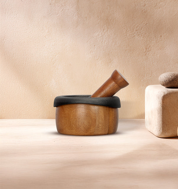 Kroslo cast iron mortar and pestle with wooden body and pestle on a beige background